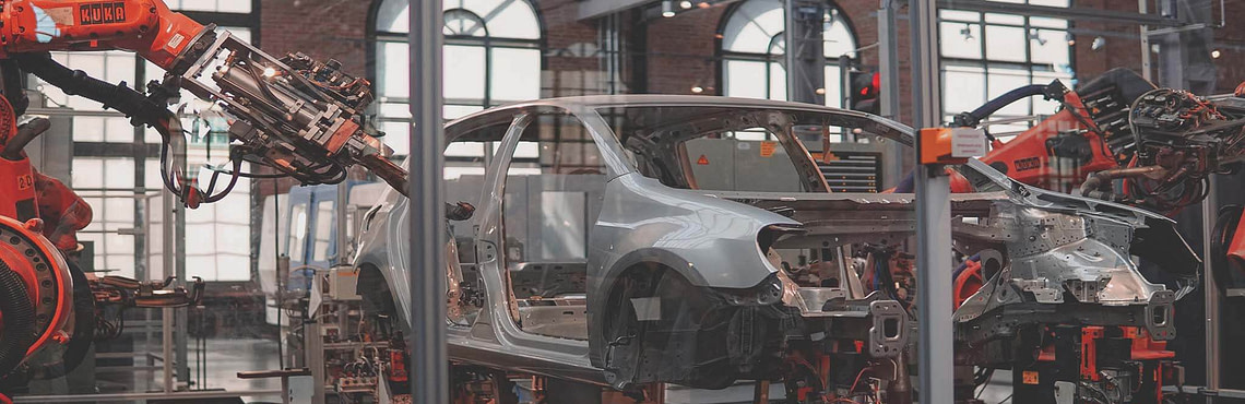 robots building a car - an example of AI use cases in manufacturing