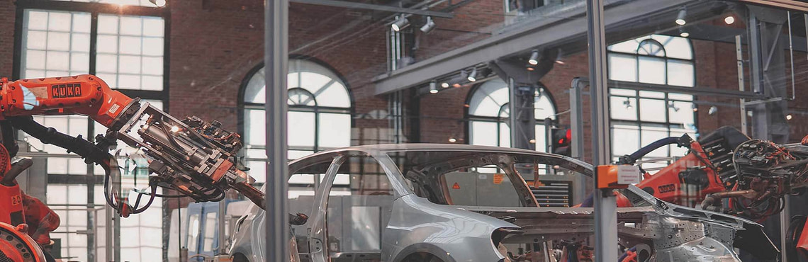 robots building a car - an example of AI use cases in manufacturing